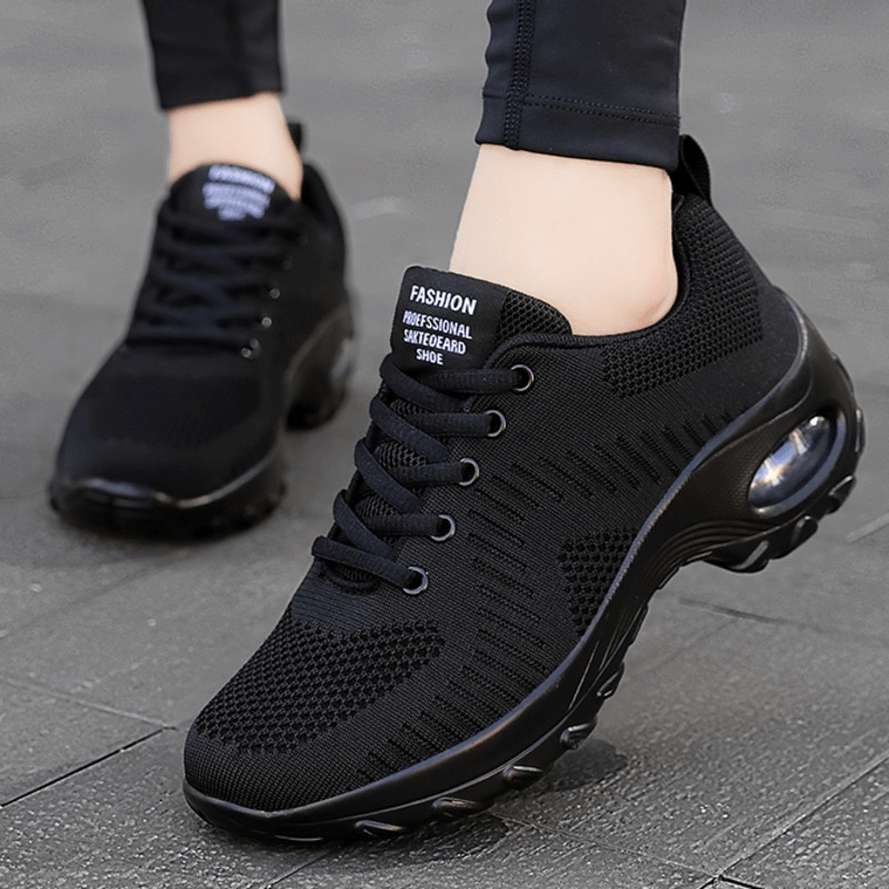 Stylish breathable black women's sneakers with mesh upper, EVA insole, and non-slip sole for superior performance.